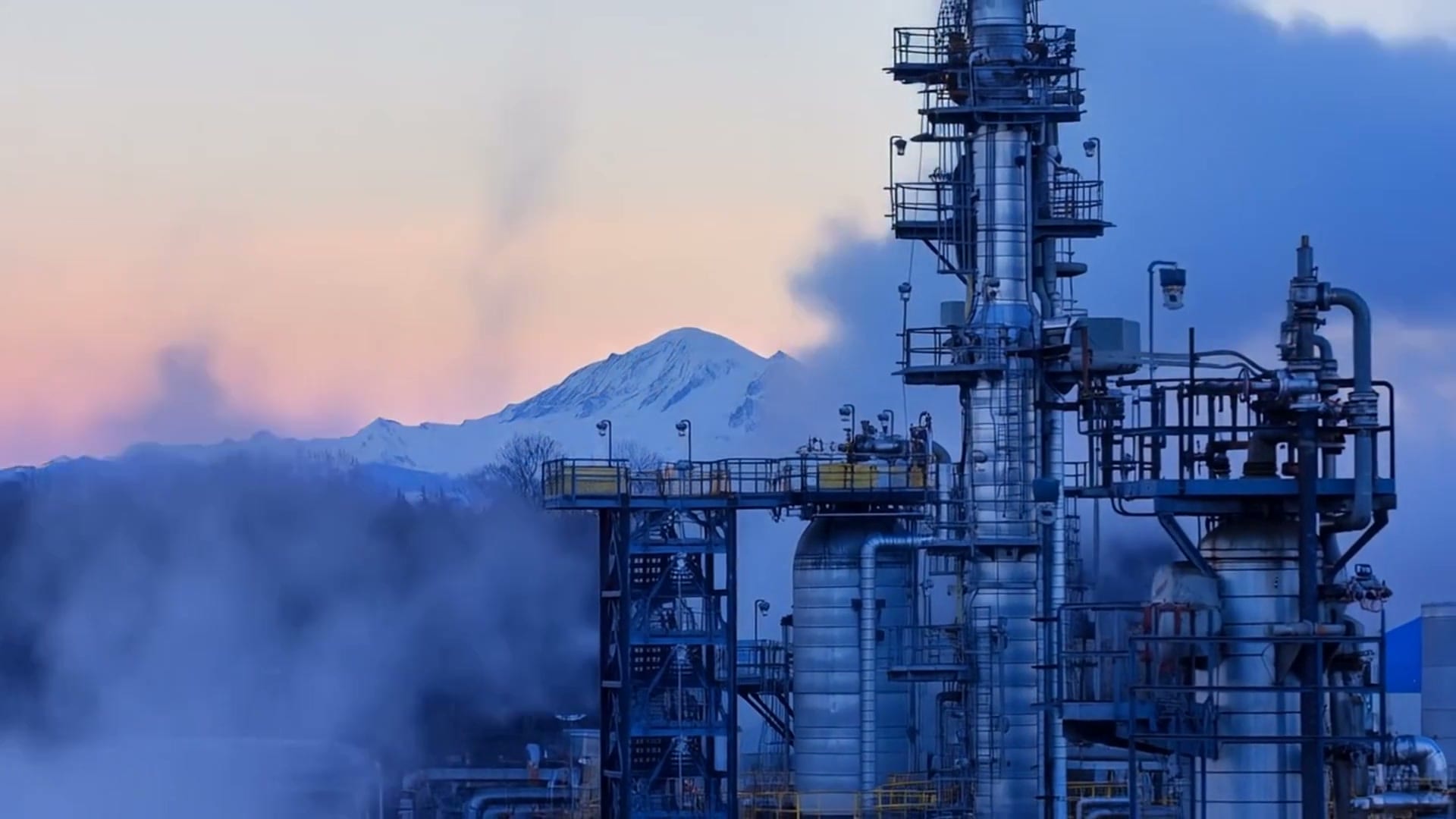 Refinery with snow-capped mountains